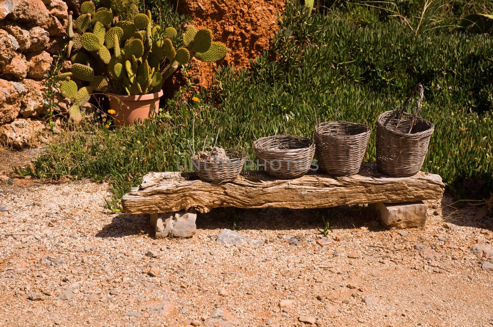 Old wicker basket on a very old bench.