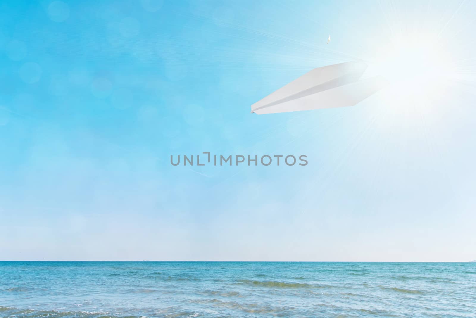 paper plane against the blue sky and sea by Zhukow