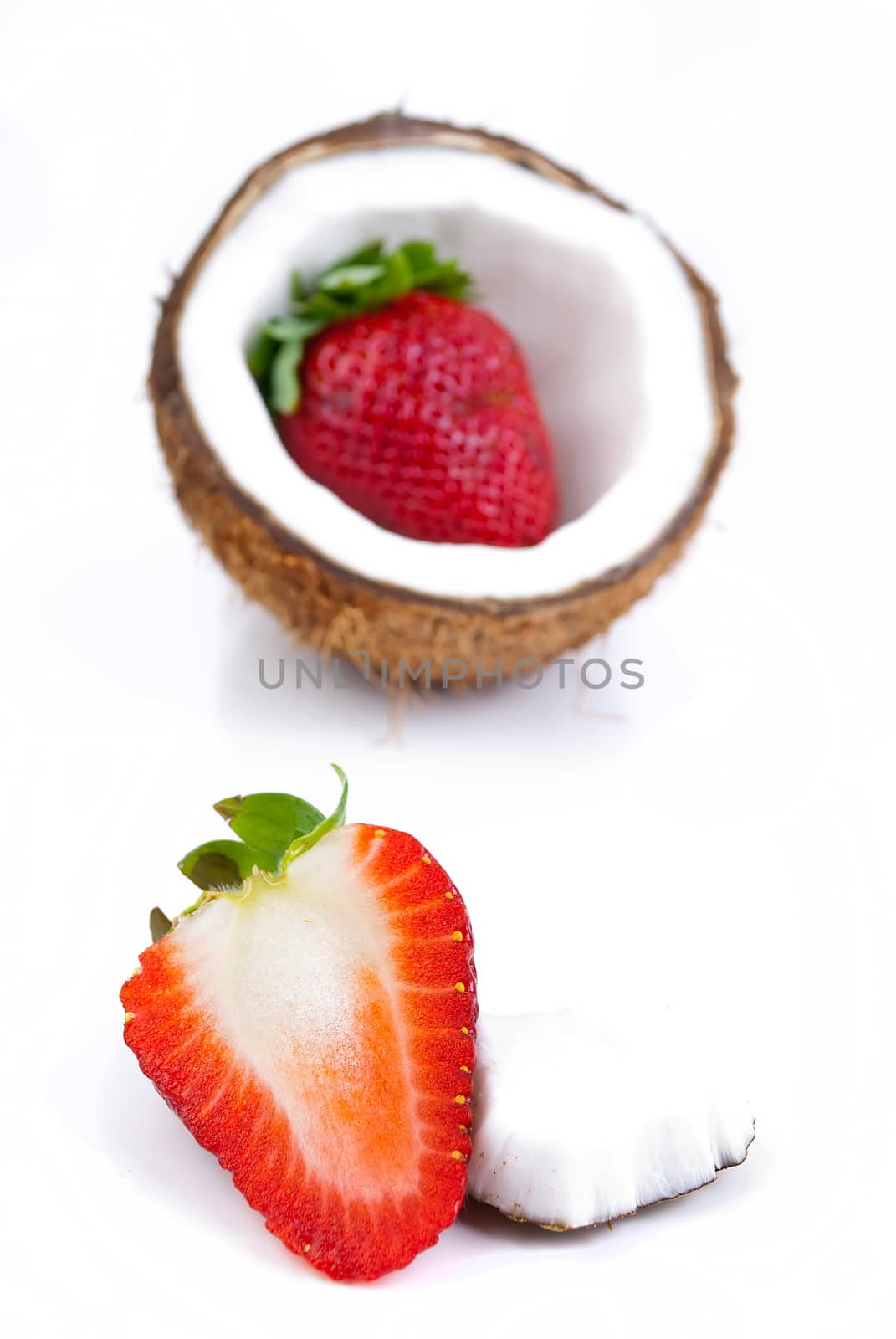 healthy fresh fruits - strawberries and coconut isolated on white background