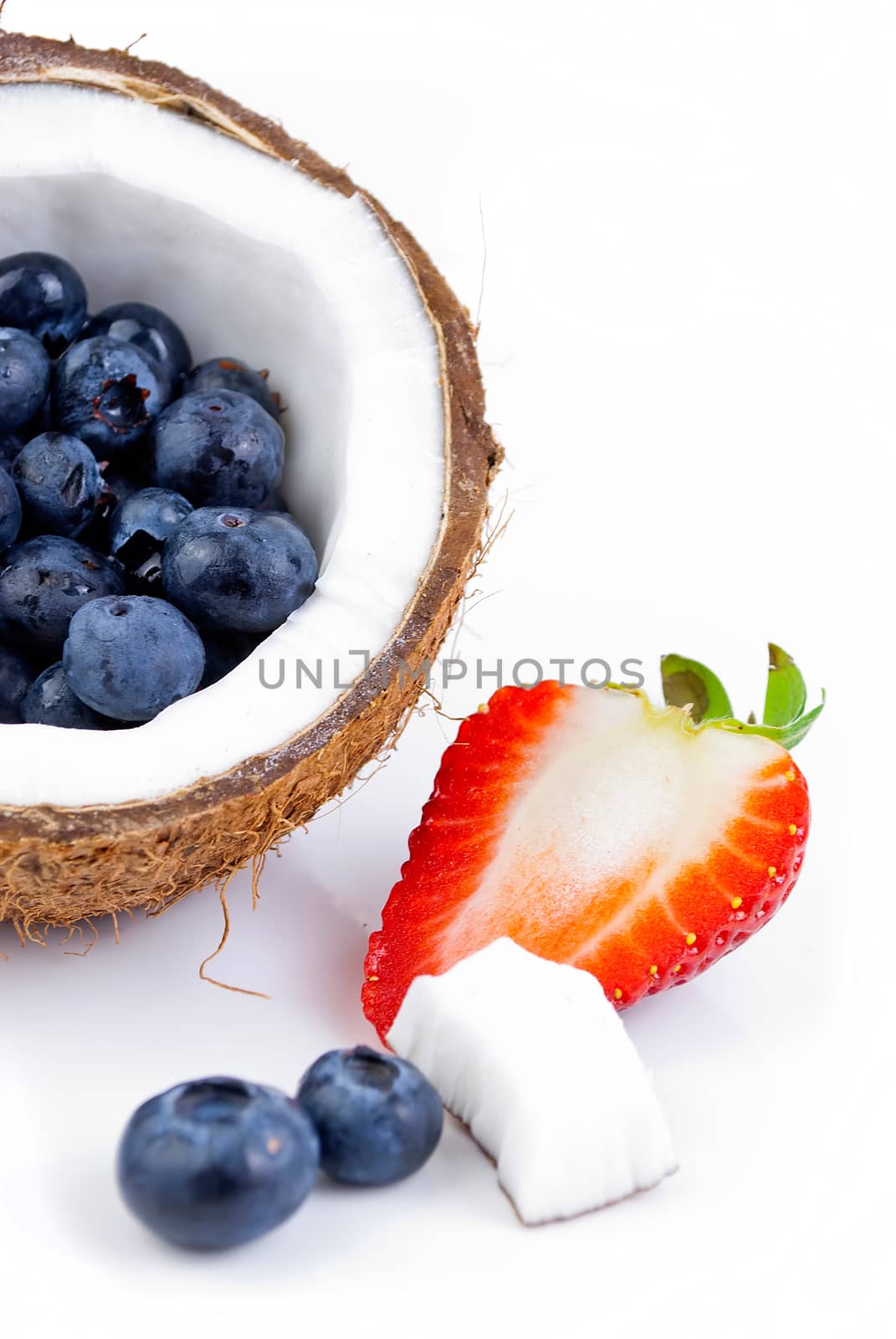 healthy fresh fruits - strawberry, blueberry and coconut isolated on white background