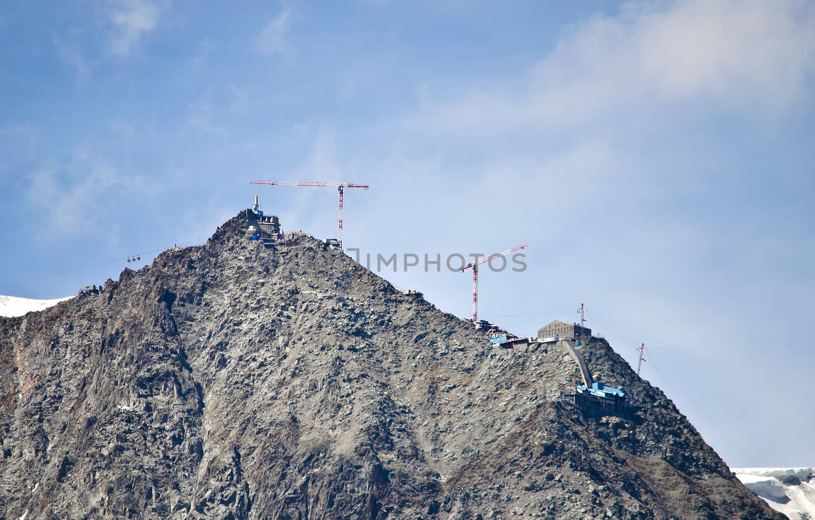 Cranes building on top of mountain by artofphoto