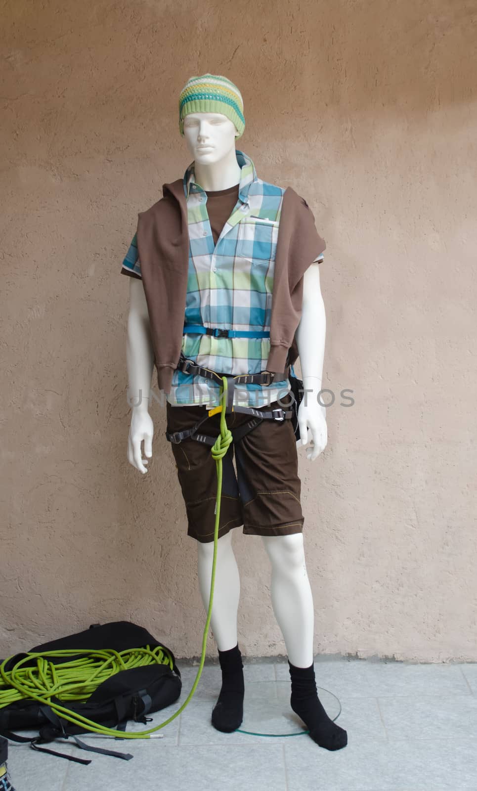One male mannequin with mountaineering equipment. Mountaineer clothes