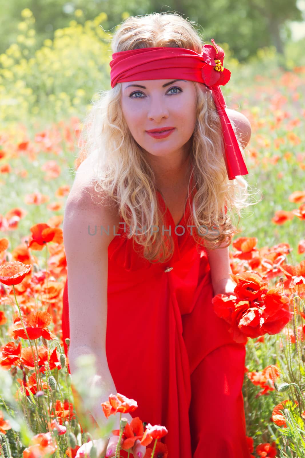 Woman in long red dress among poppy field by Angel_a