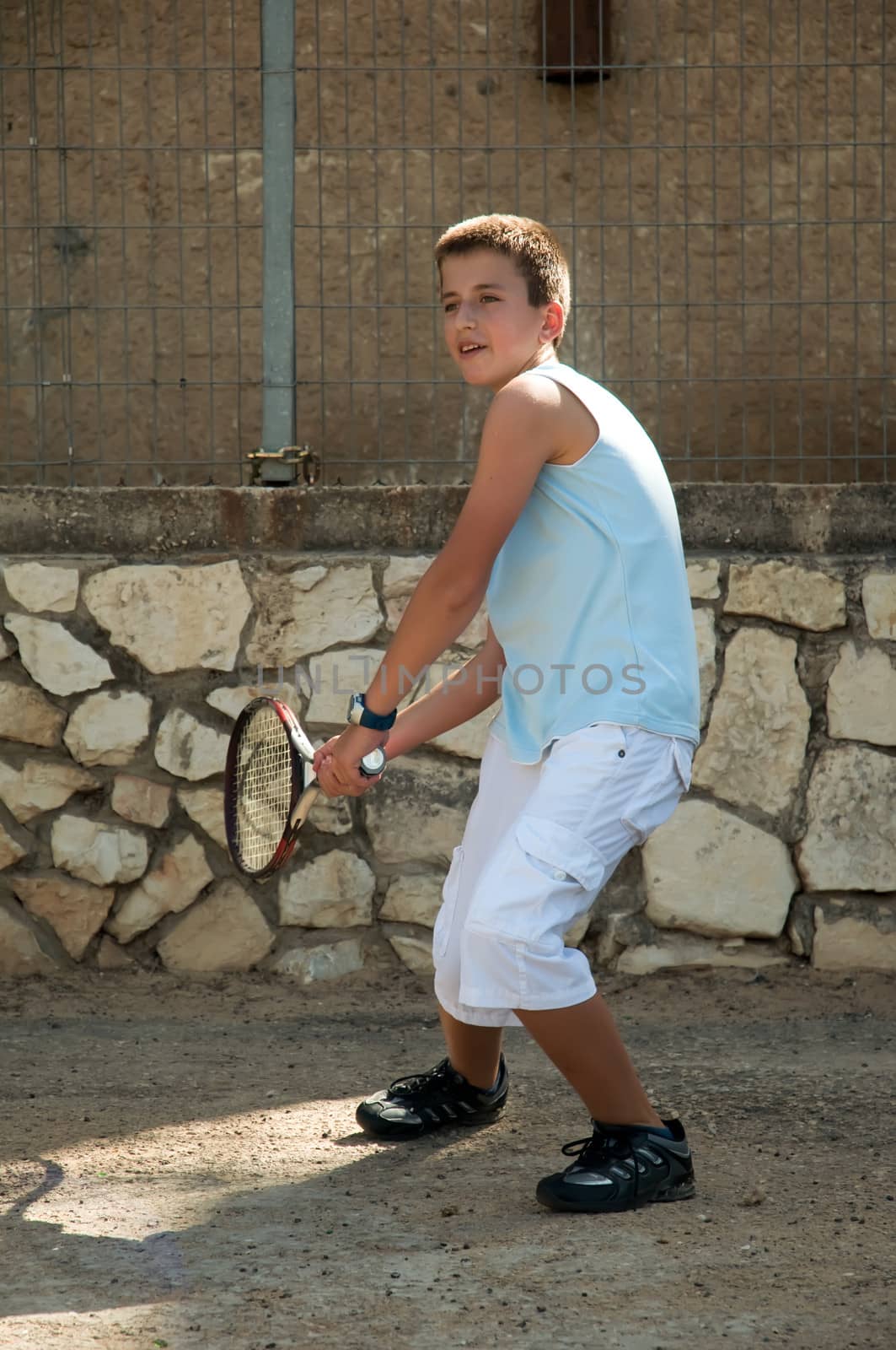 Young boy with tennis racket . by LarisaP