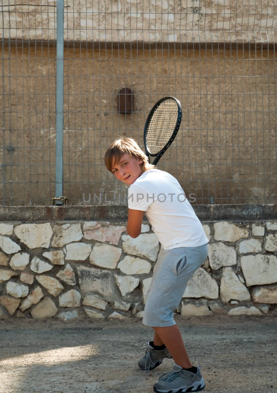 Young boy with tennis racket . by LarisaP