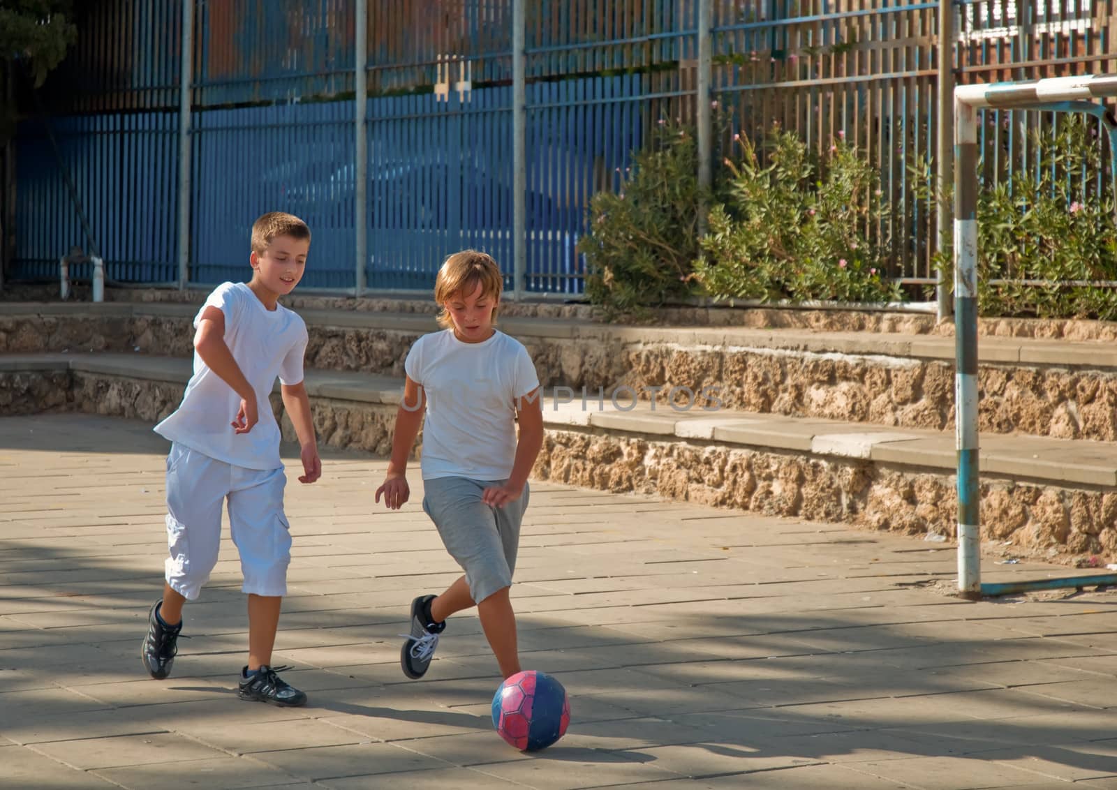 Two boys  playing football. by LarisaP