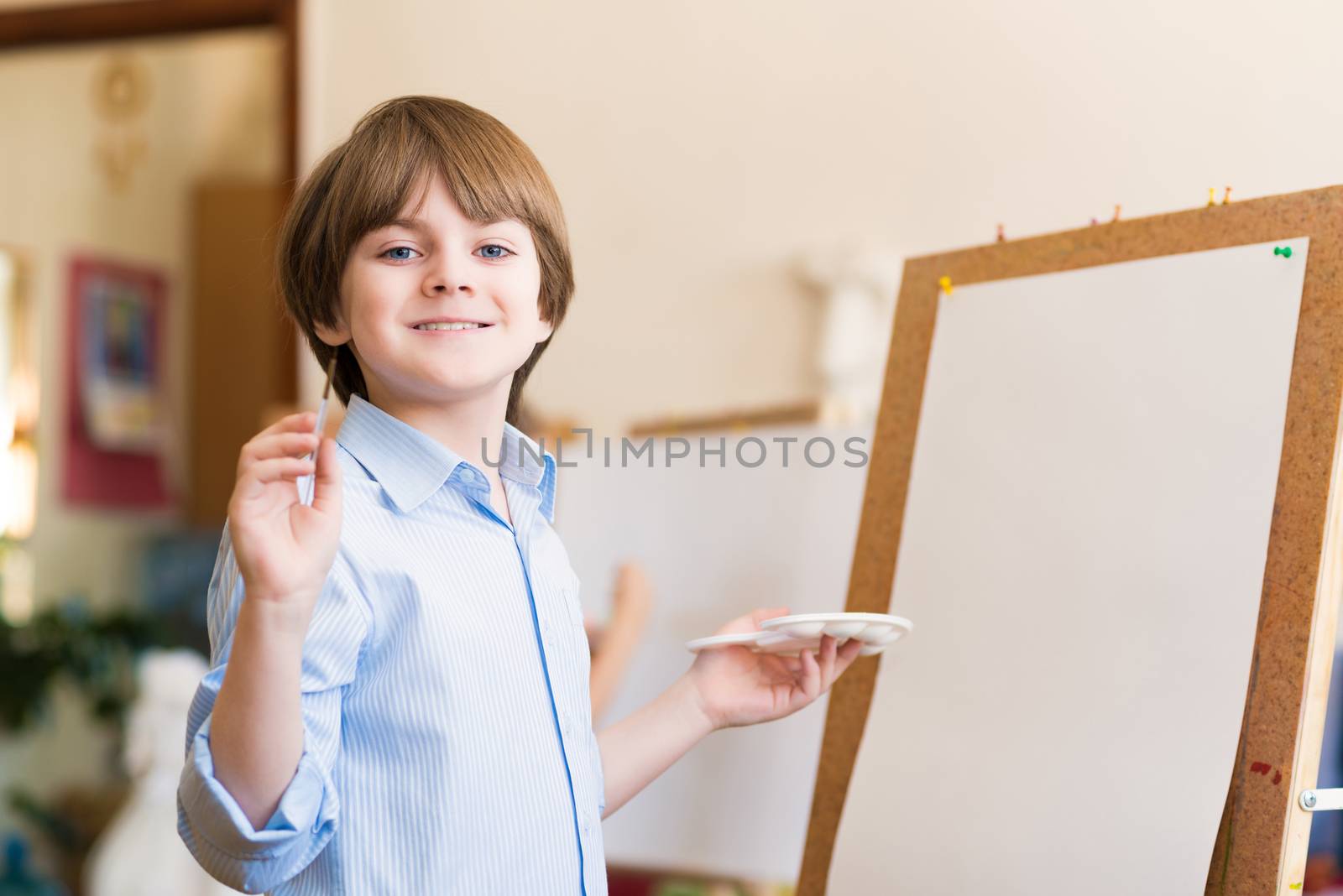 portrait of a boy standing next to his easel, a drawing lesson