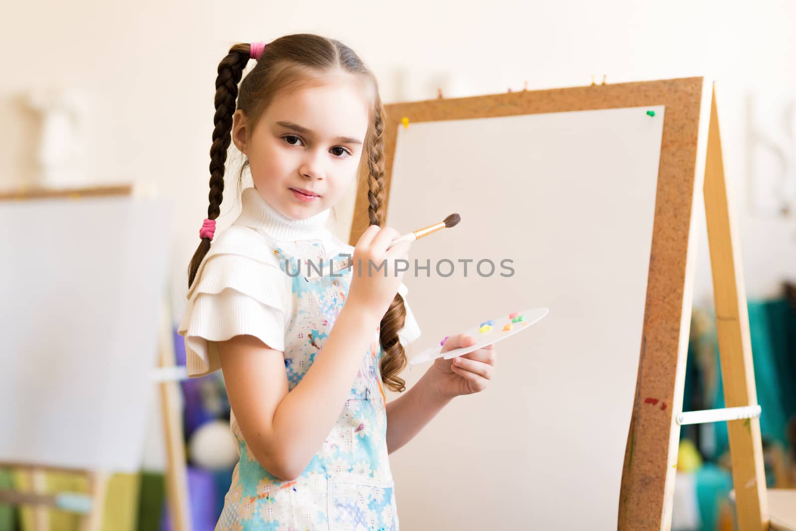 portrait of a girl standing next to his easel, a drawing lesson