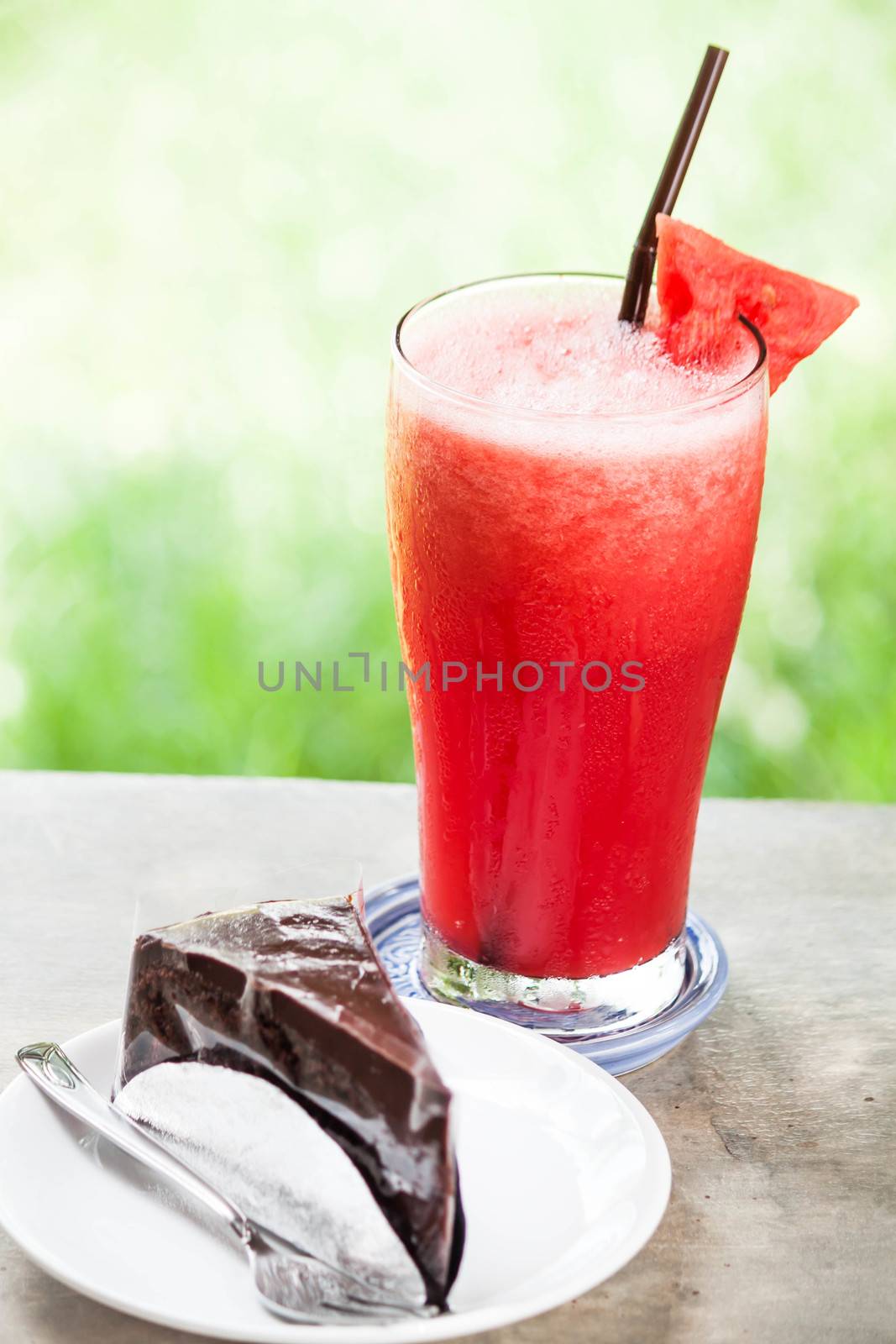 Break time with water melon fruit juice and chocolate cake by punsayaporn