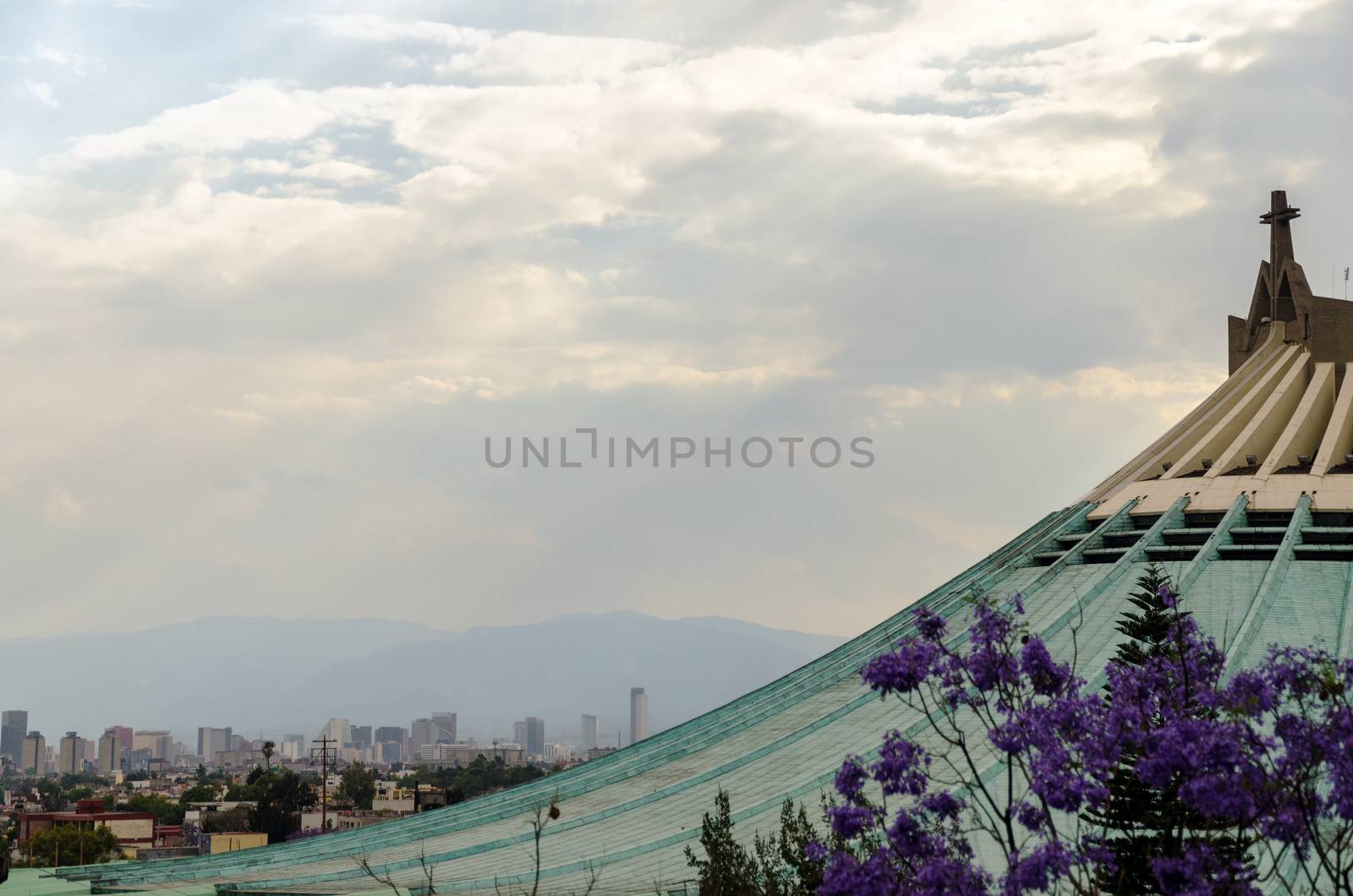 Roof of the Basilica of our Lady of Guadalupe with Mexico City skyscrapers in the background