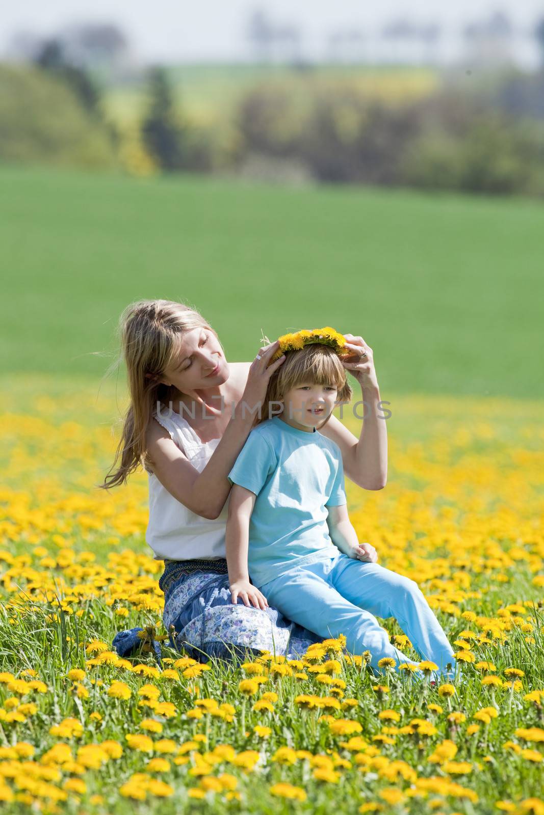 mother and son in dandelion field by courtyardpix