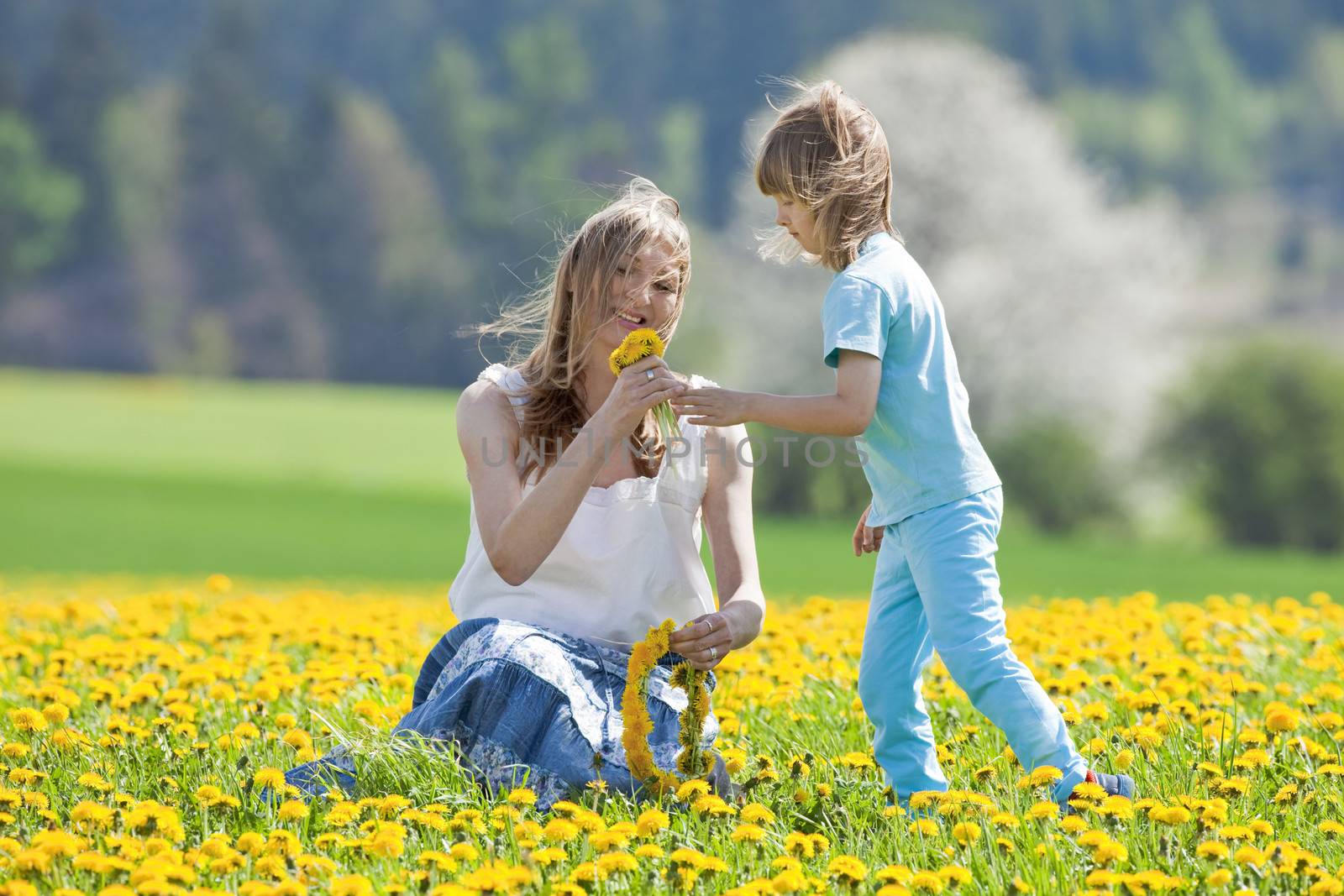 mother and son in dandelion field by courtyardpix