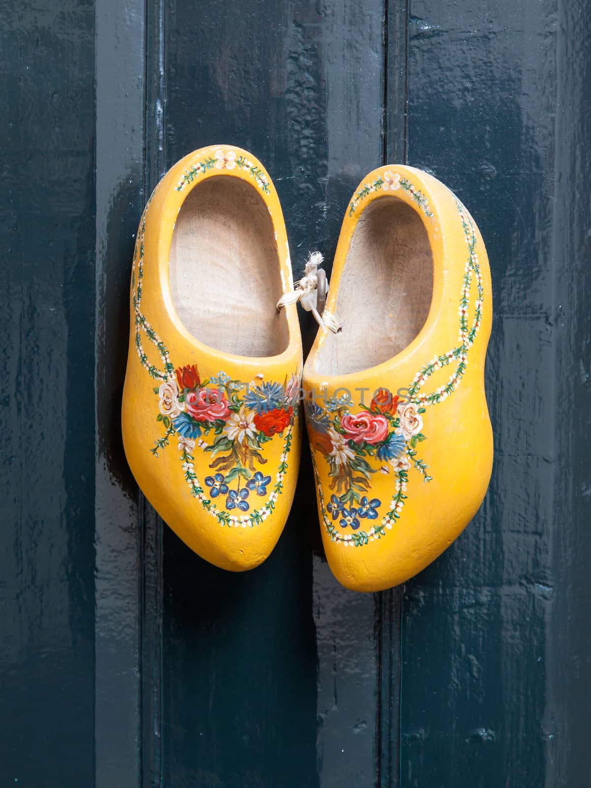 Dutch wooden shoes hanging by michaklootwijk