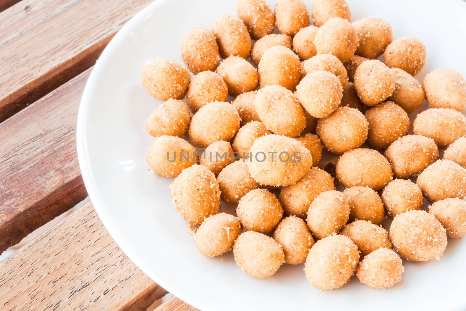 Spicy peanuts snack on white dish, stockphoto