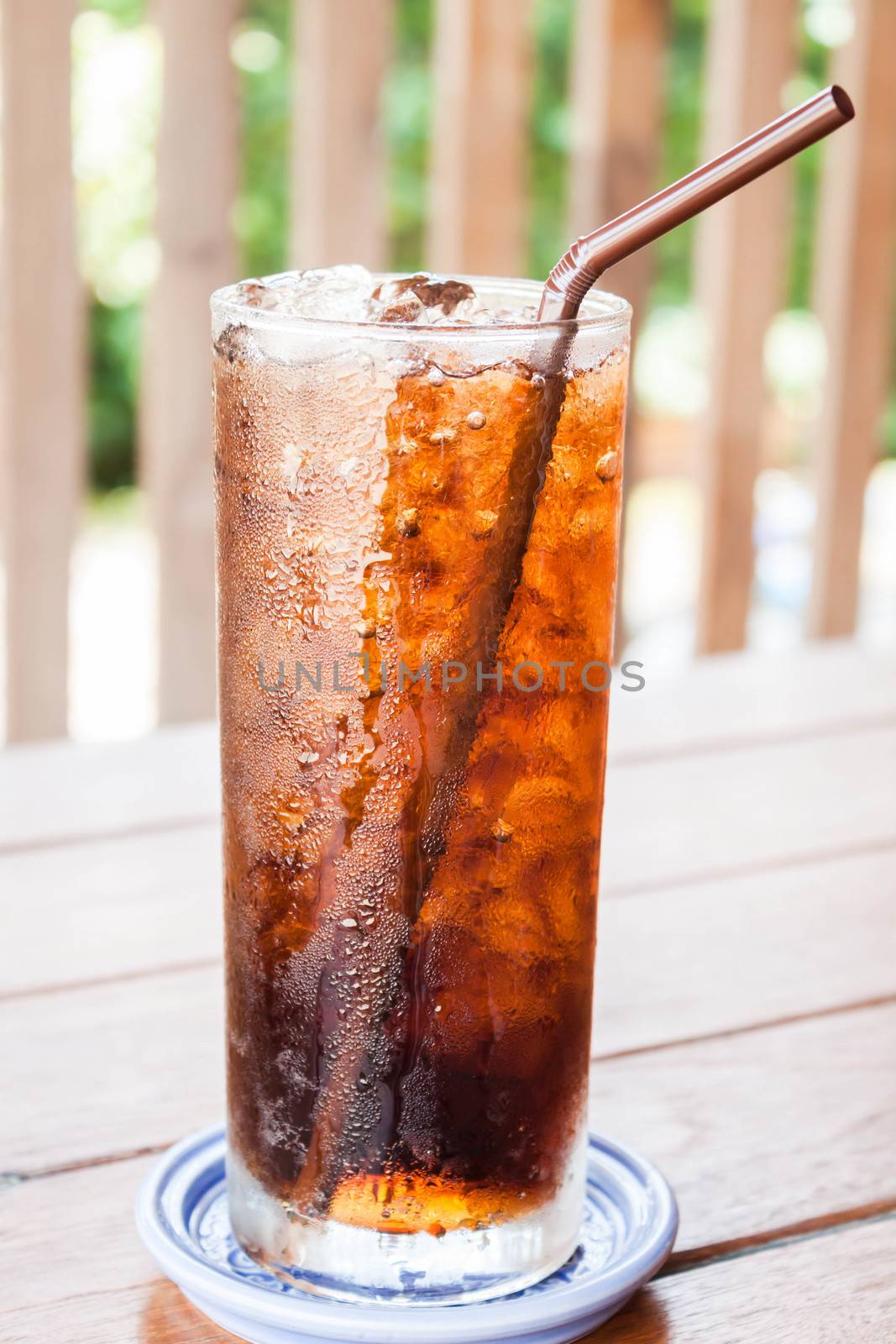 A glass of fresh cola drink with ice by punsayaporn