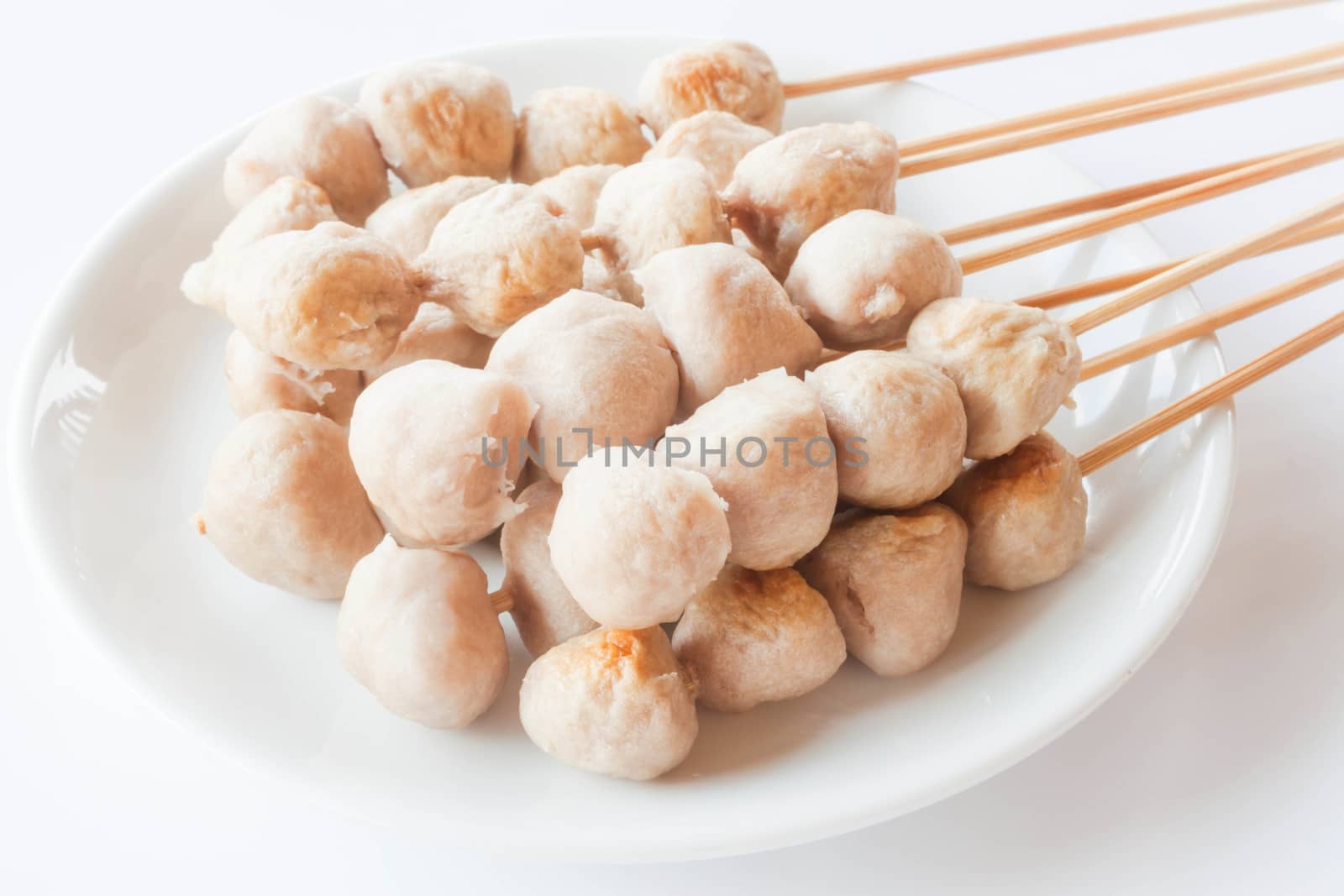 Mini pork balls in white plate on clean table by punsayaporn