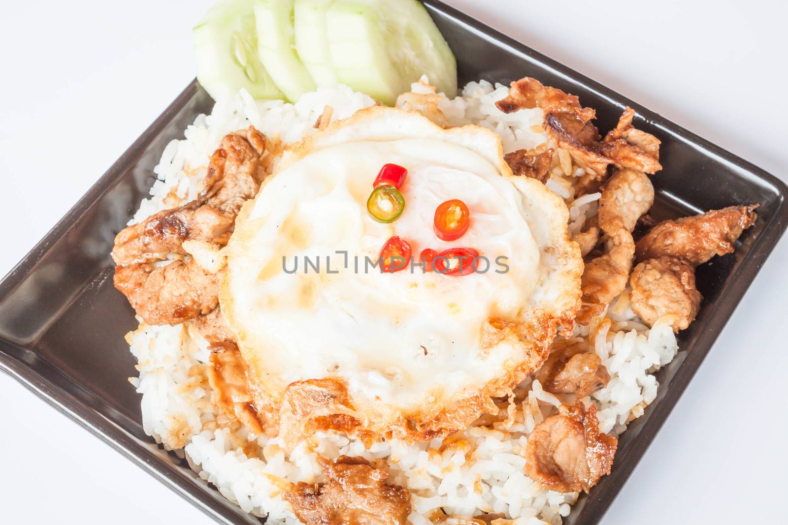Egg fried and fried pork garlic with soy sauce topped on rice by punsayaporn