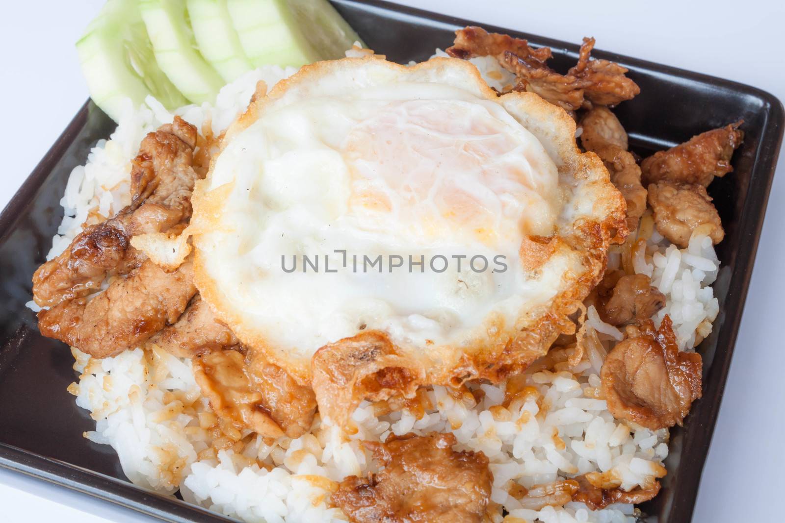 Egg fried and fried pork garlic with soy sauce topped on rice by punsayaporn