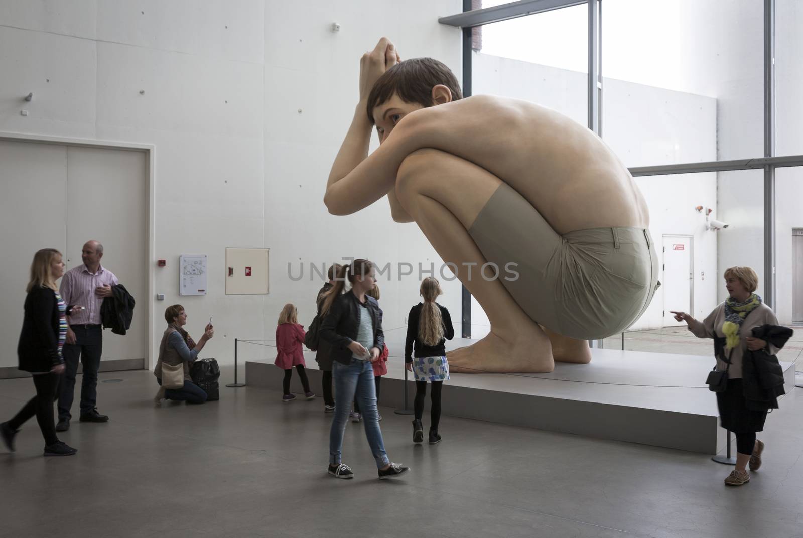 AARHUS, DENMARK - MAY 25: Boy made of the Australian sculptor Ron Mueck exhibited in Aros - The art Museum of Aarhus, Denmark May 25, 2013. Ron Mueck has made fine art since 1996.