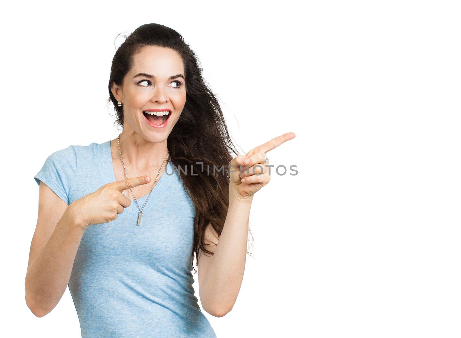 An attractive energetic happy woman pointing and looking at copy-space. Isolated on white.