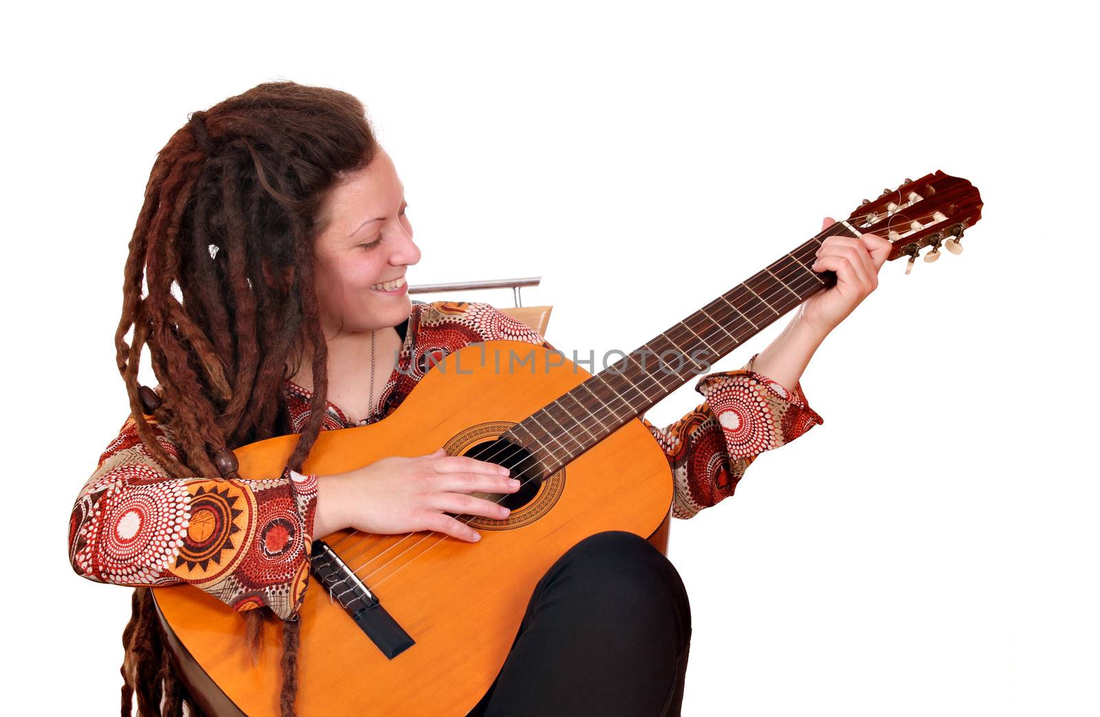 girl with dreadlocks hair play acoustic guitar by goce