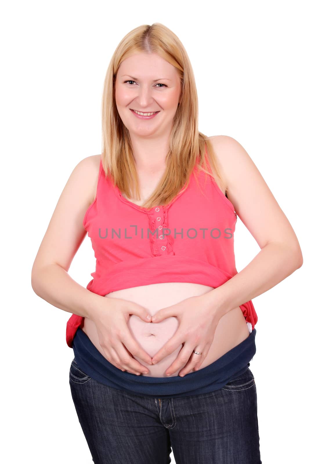 pregnant woman makes heart sign on belly