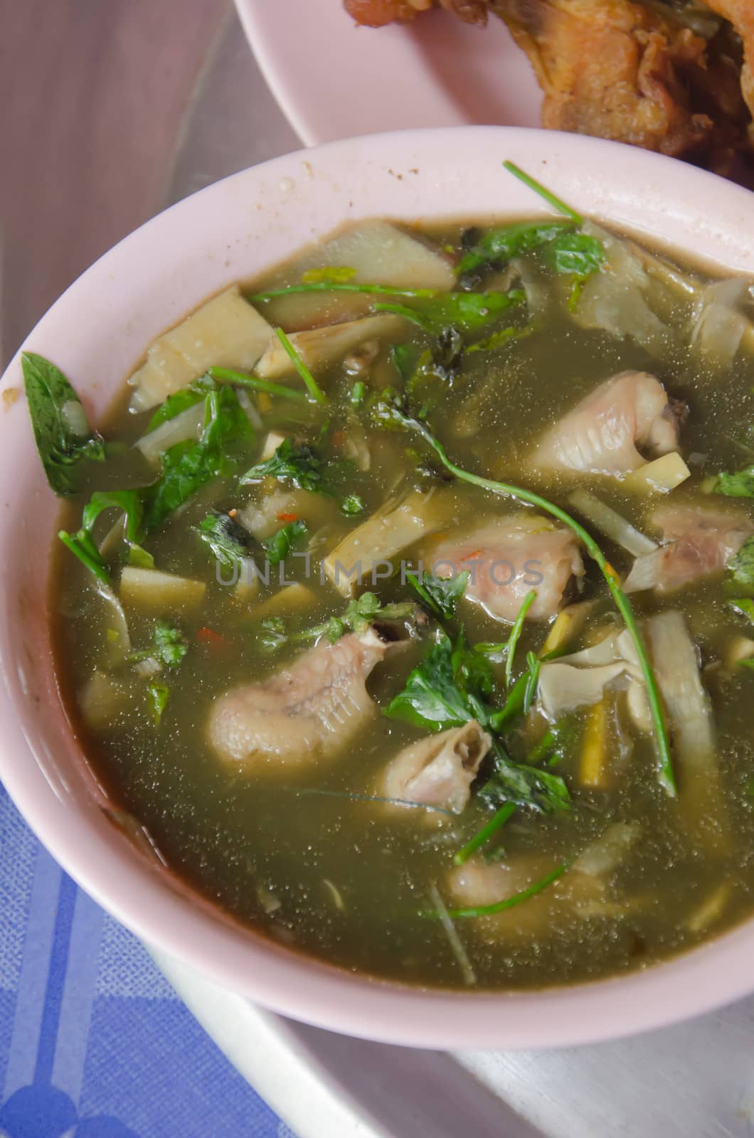 A savoury thick soup made from chicken , spices and vegetables