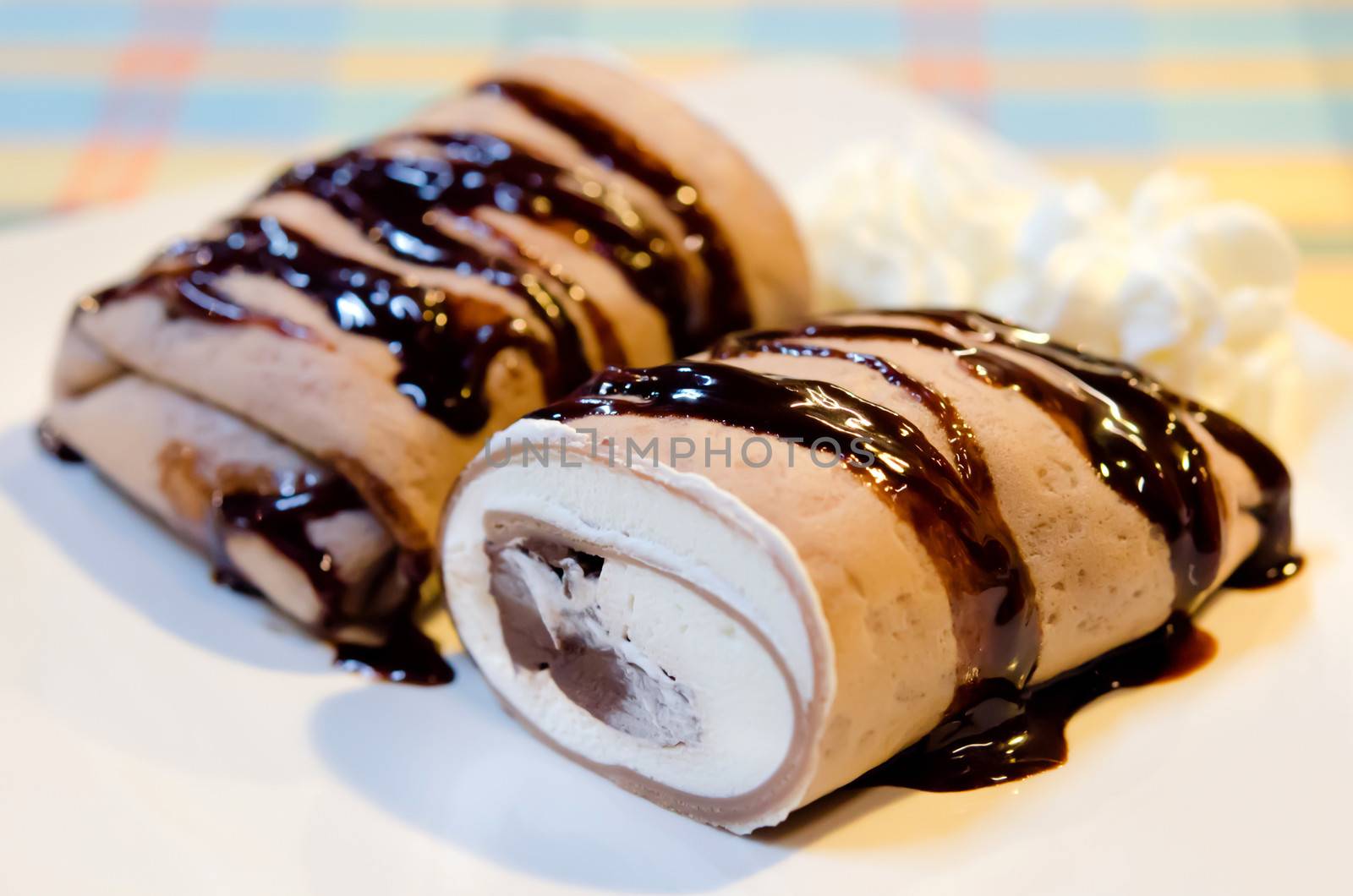 crepe rolls filled  with white cream and chocolate  , topping with chocolate  syrup