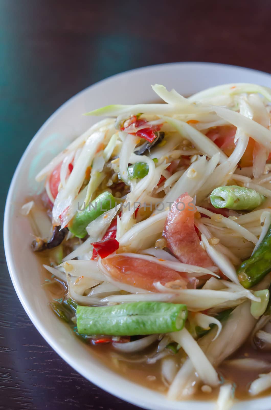 spicy papaya salad and vegetable on white dish