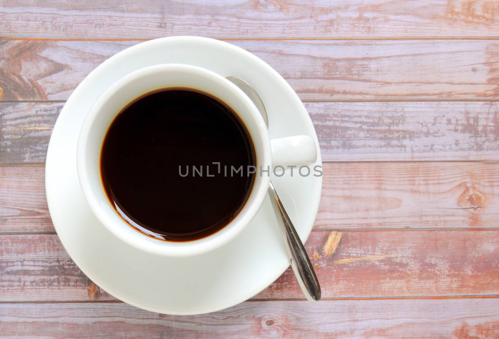 Black coffee in white cup with spoon by nuchylee