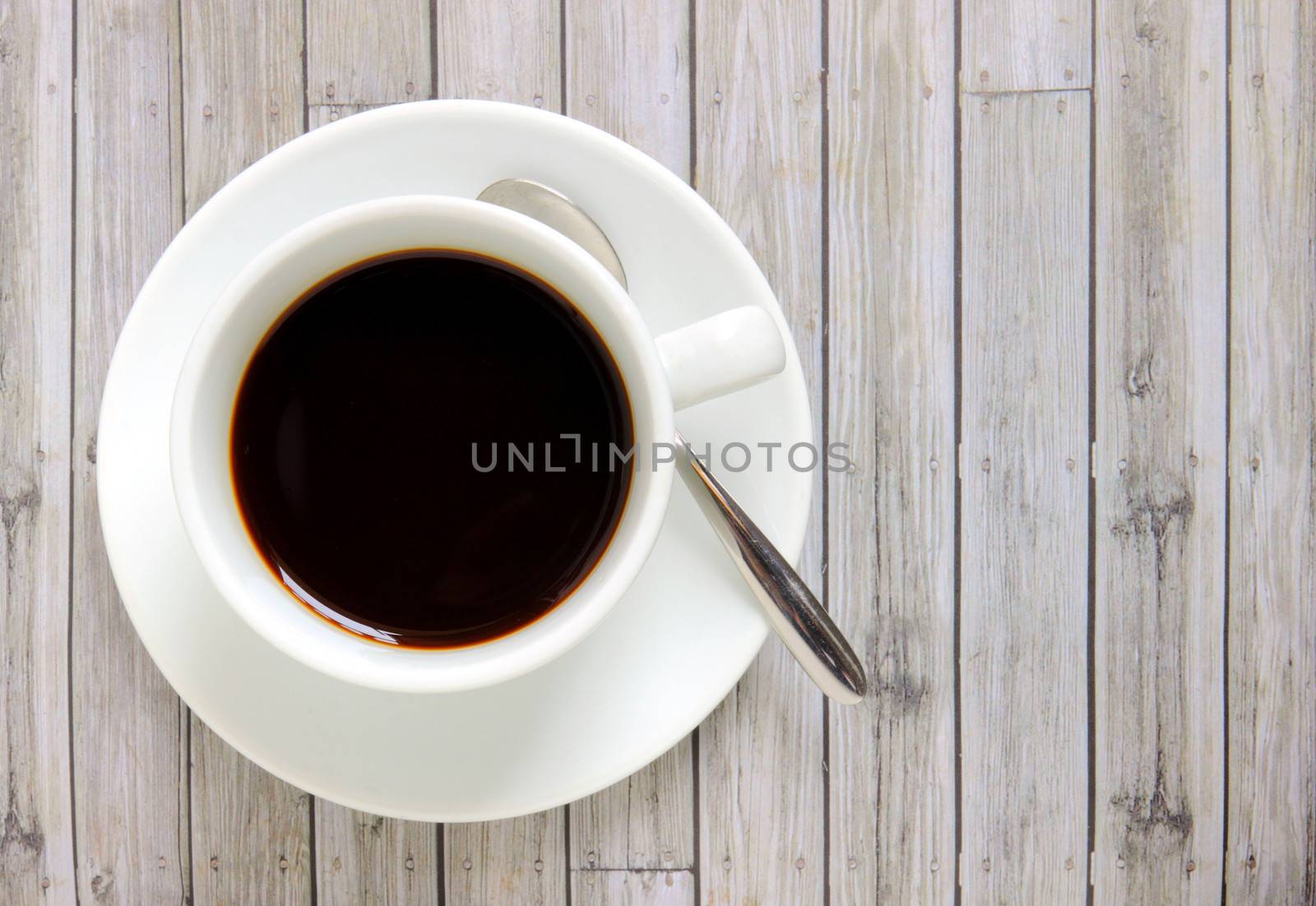 Black coffee in white cup with spoon by nuchylee