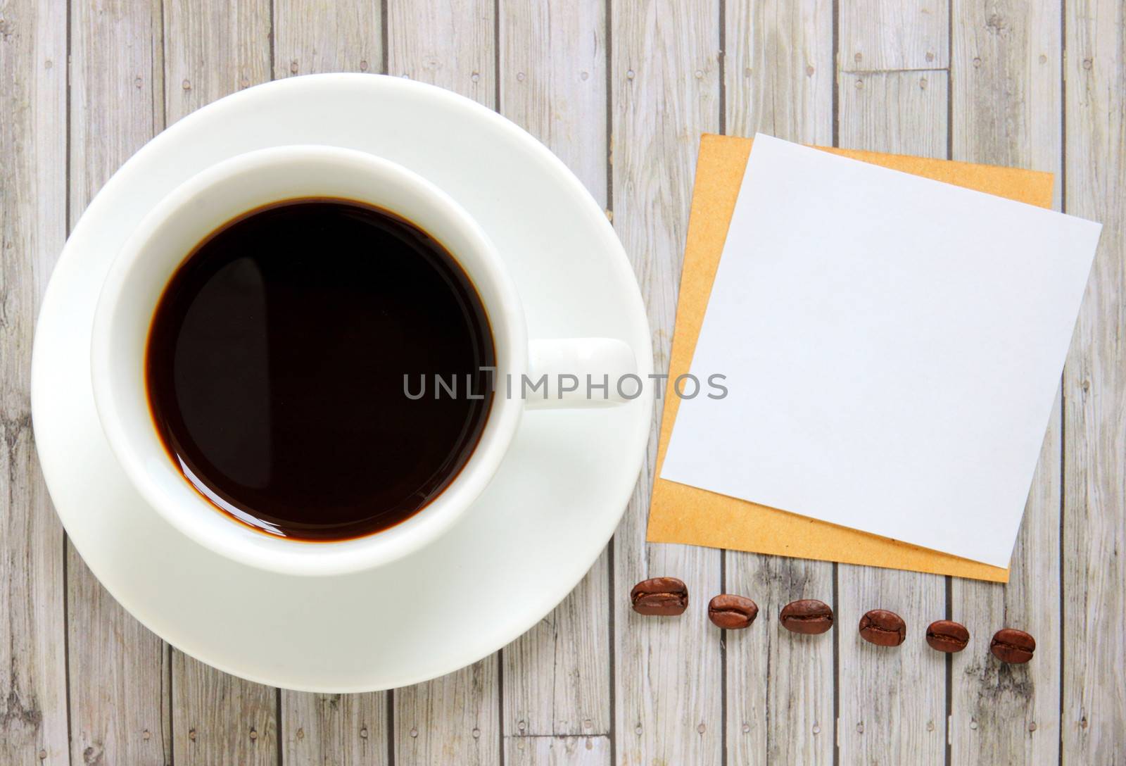 Blank paper with hot coffee cup and coffee beans by nuchylee