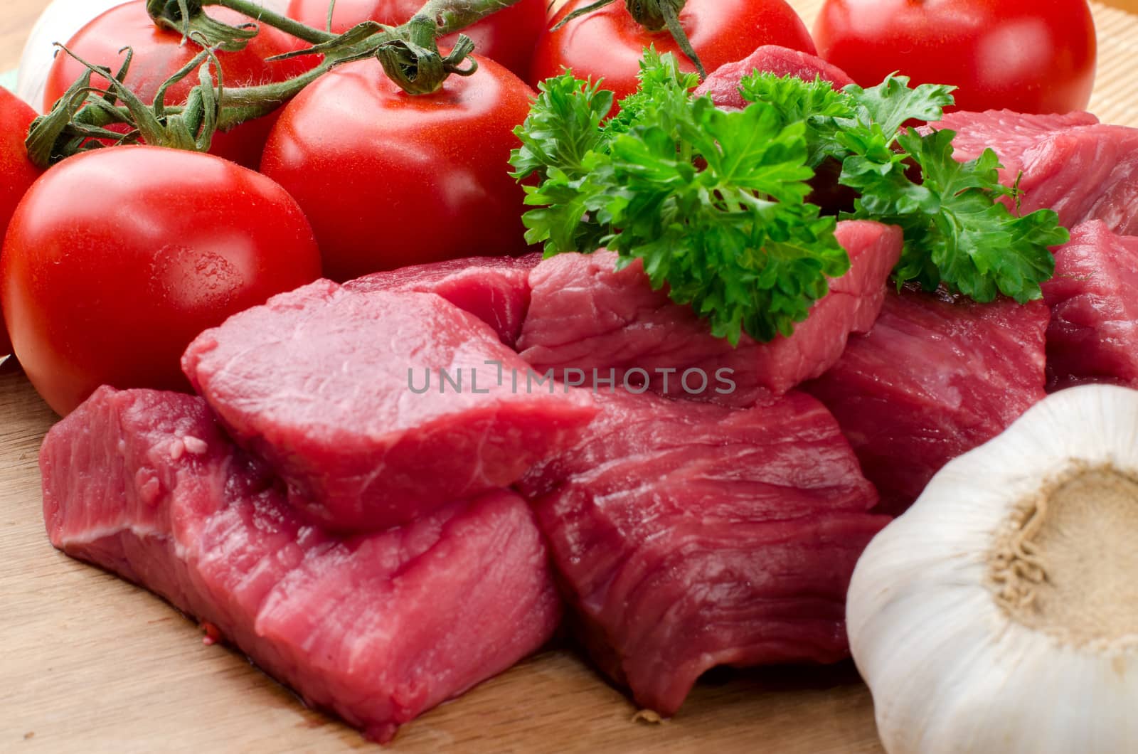Fresh raw meat on wooden board.