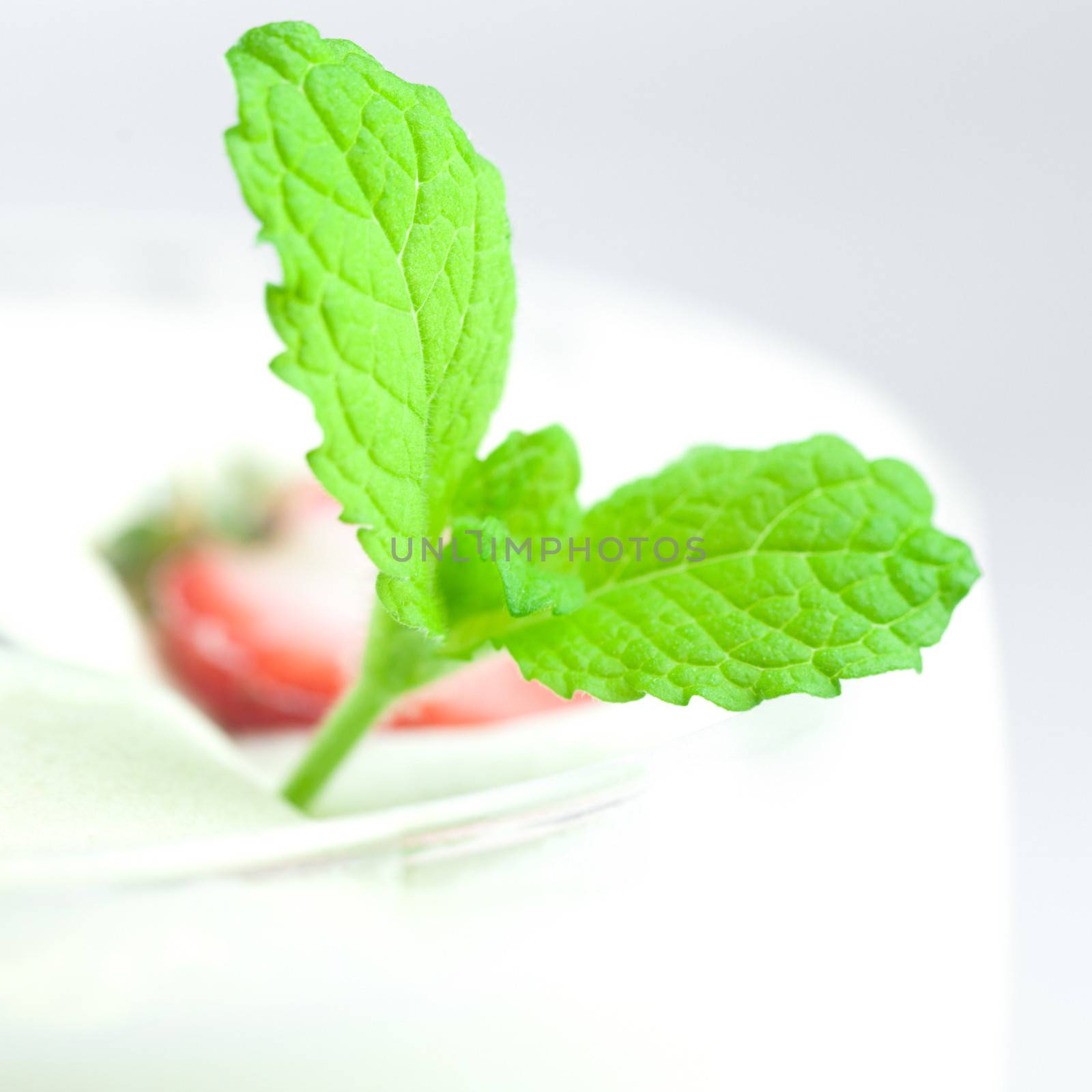 mint with strawberry on white plate