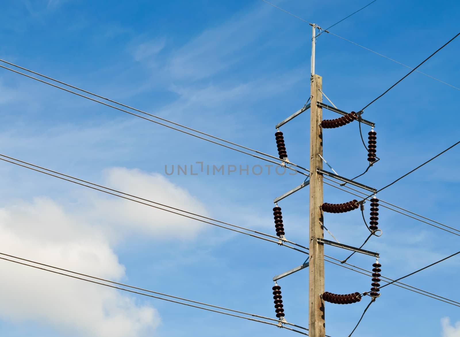 Electric pole  with wires against blue sky