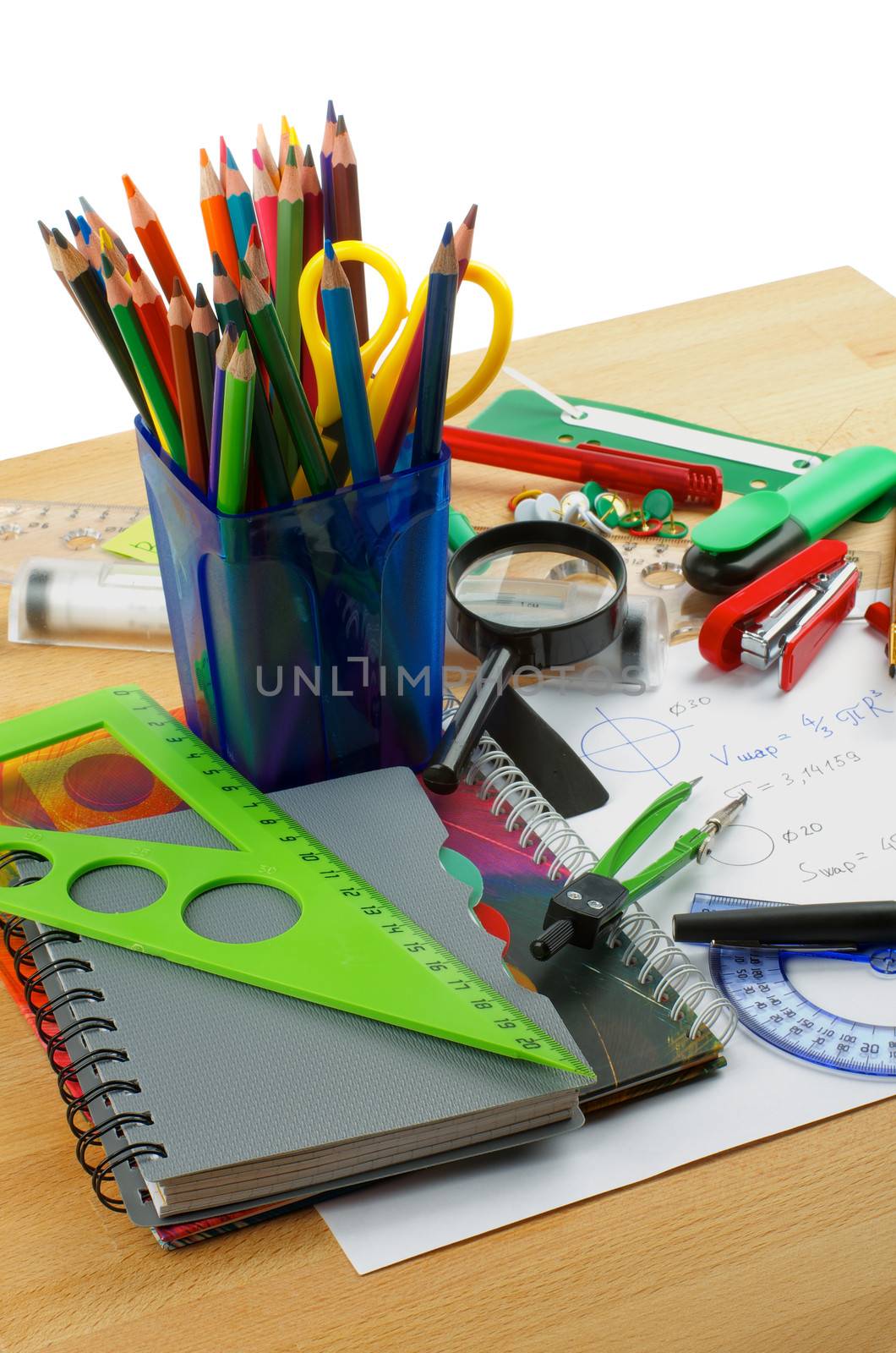 School Supplies with Note Pads, Pencils, Pens, Colored Pencils, Scissors, Pencil Sharpener, Buttons, Drawing Compass, Magnifier, Stapler, Slide-Rule and Ruler Lines on Edge of School Desk 