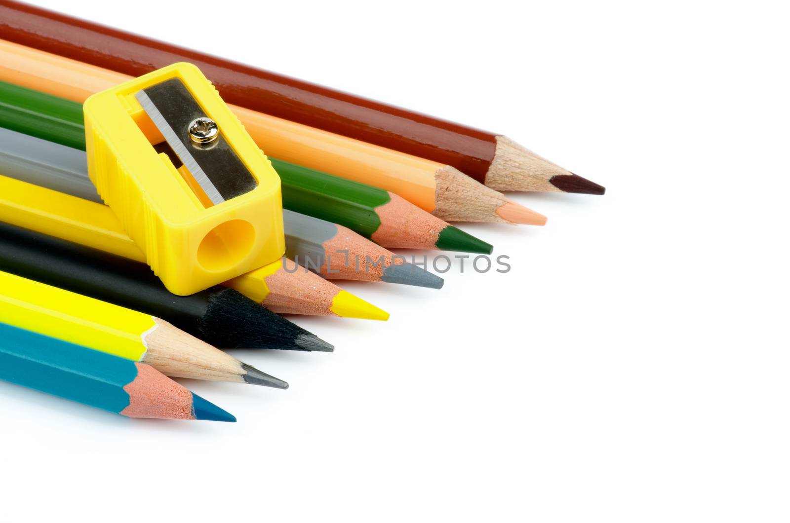 Arrangement of Sharp Lead and Colored Pencils with Pencil Sharpener isolated on white background