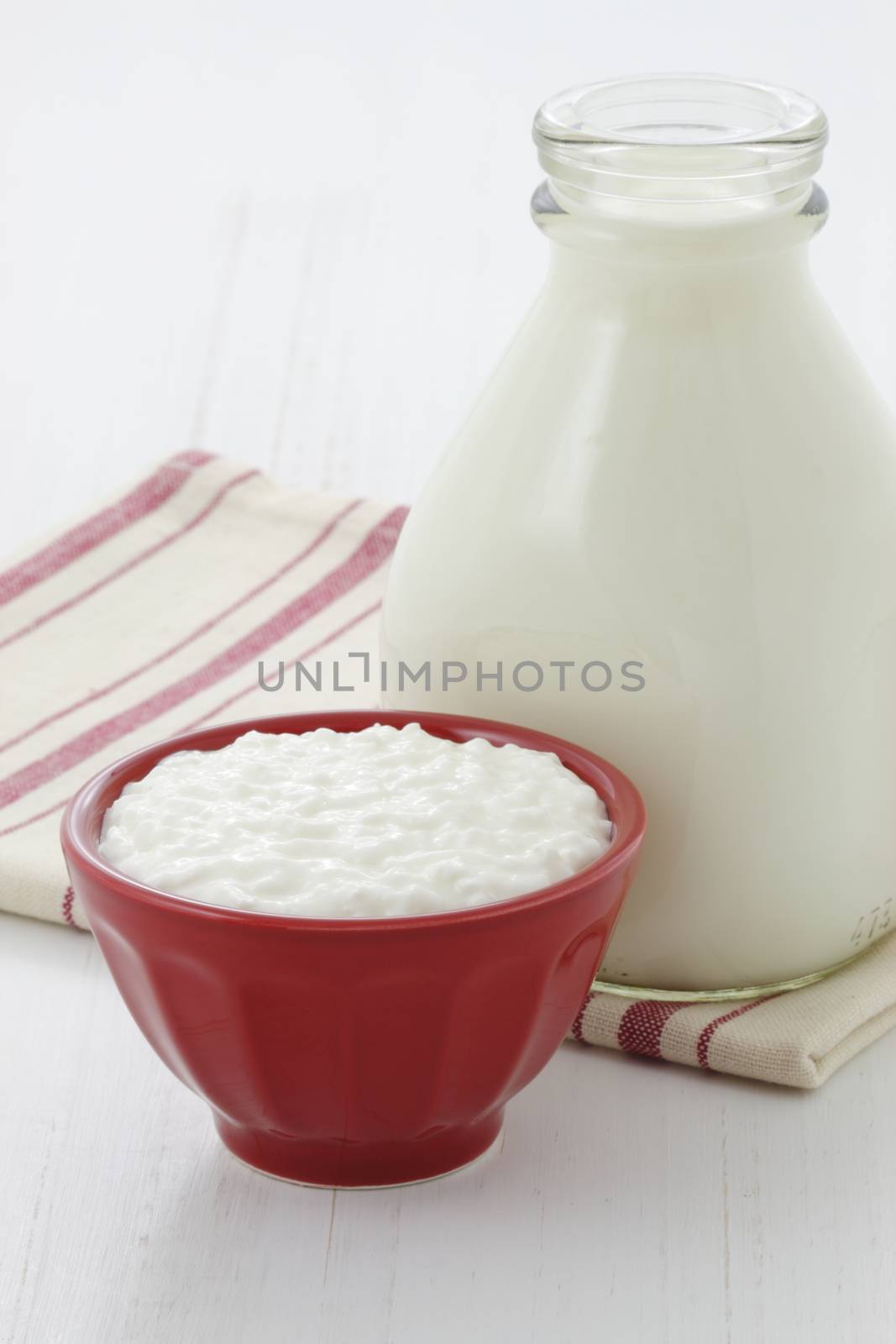 Cottage cheese and fresh milk on vintage french table linen.