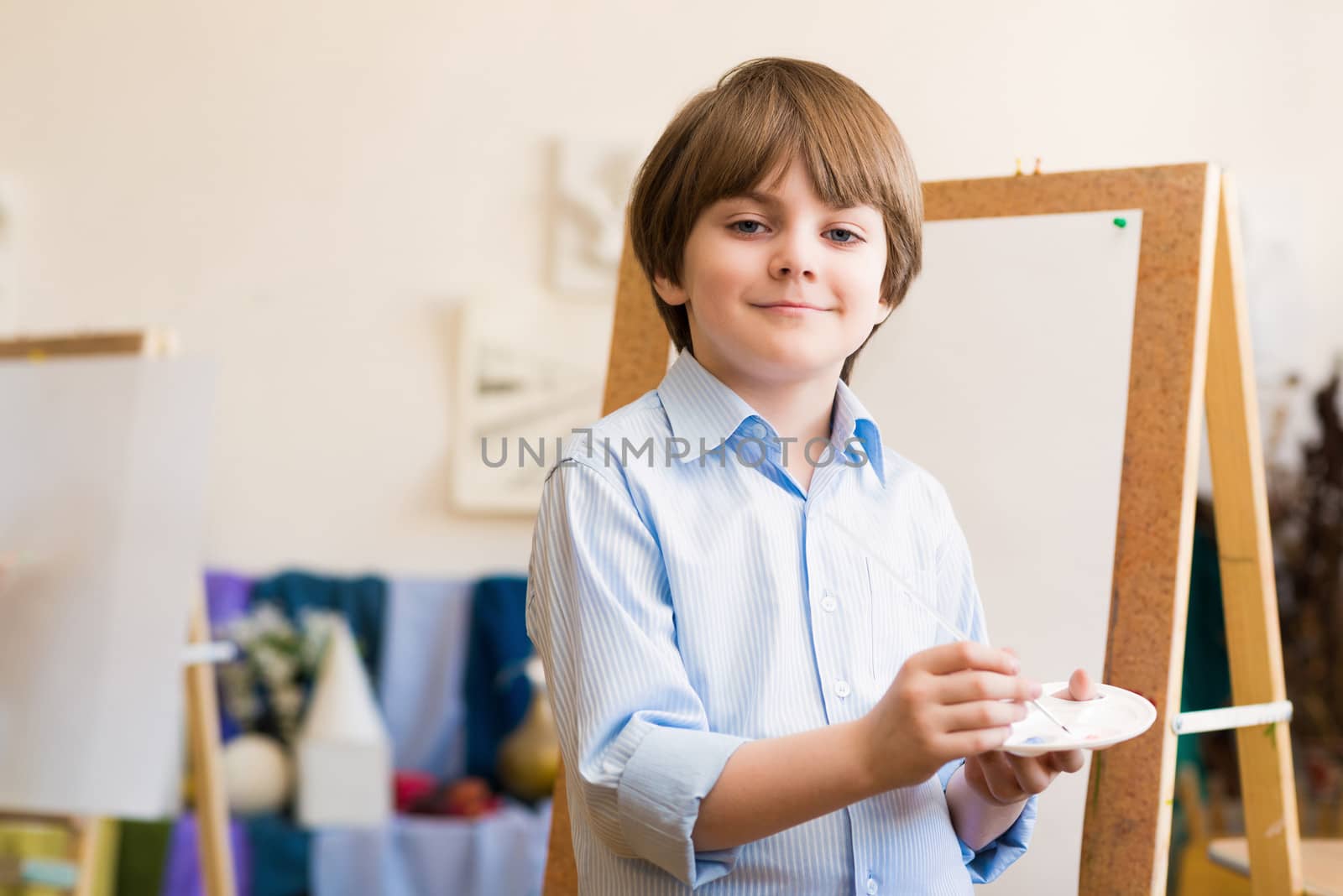 portrait of a boy standing next to his easel, a drawing lesson