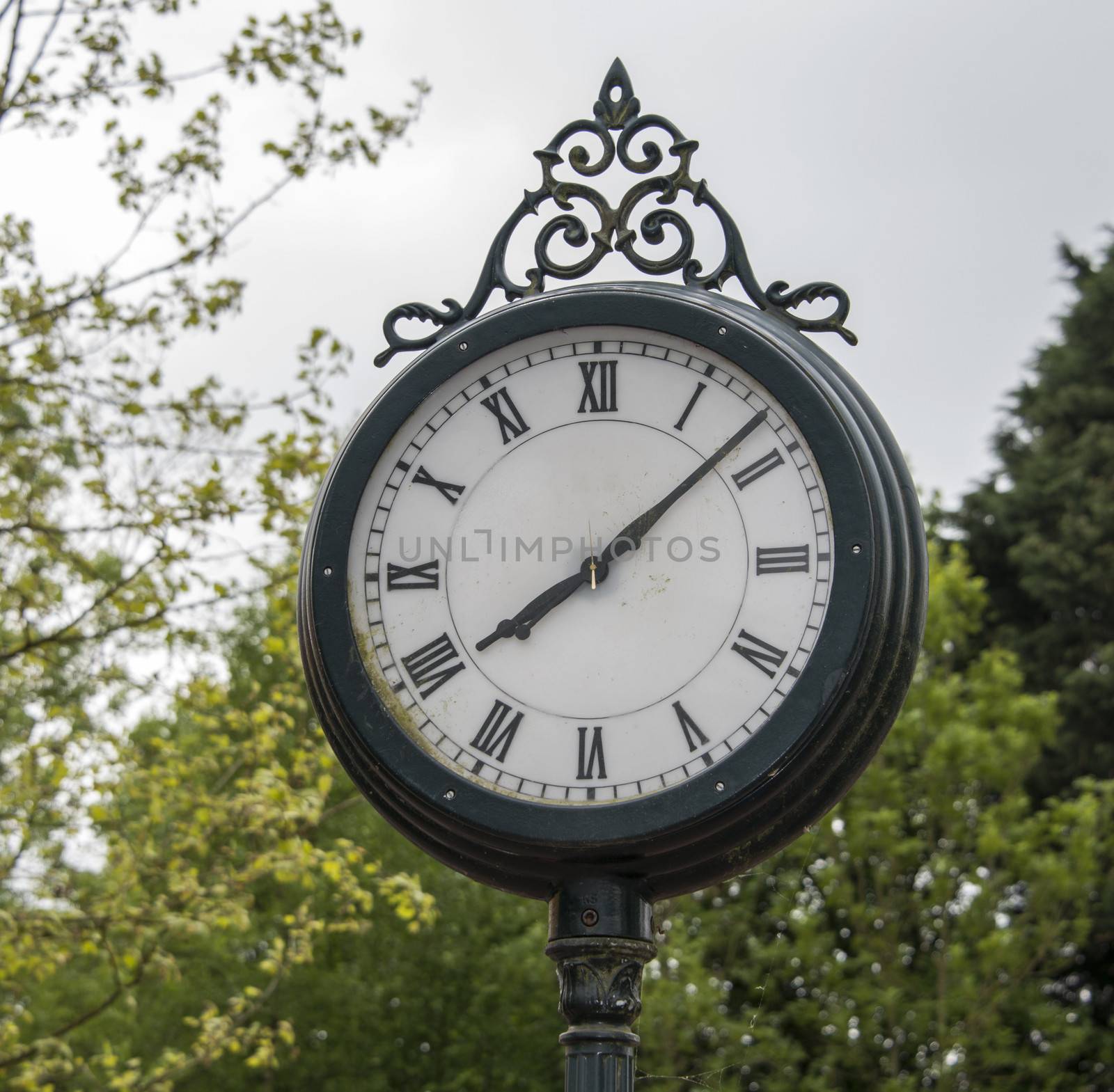 old iron clock on train station