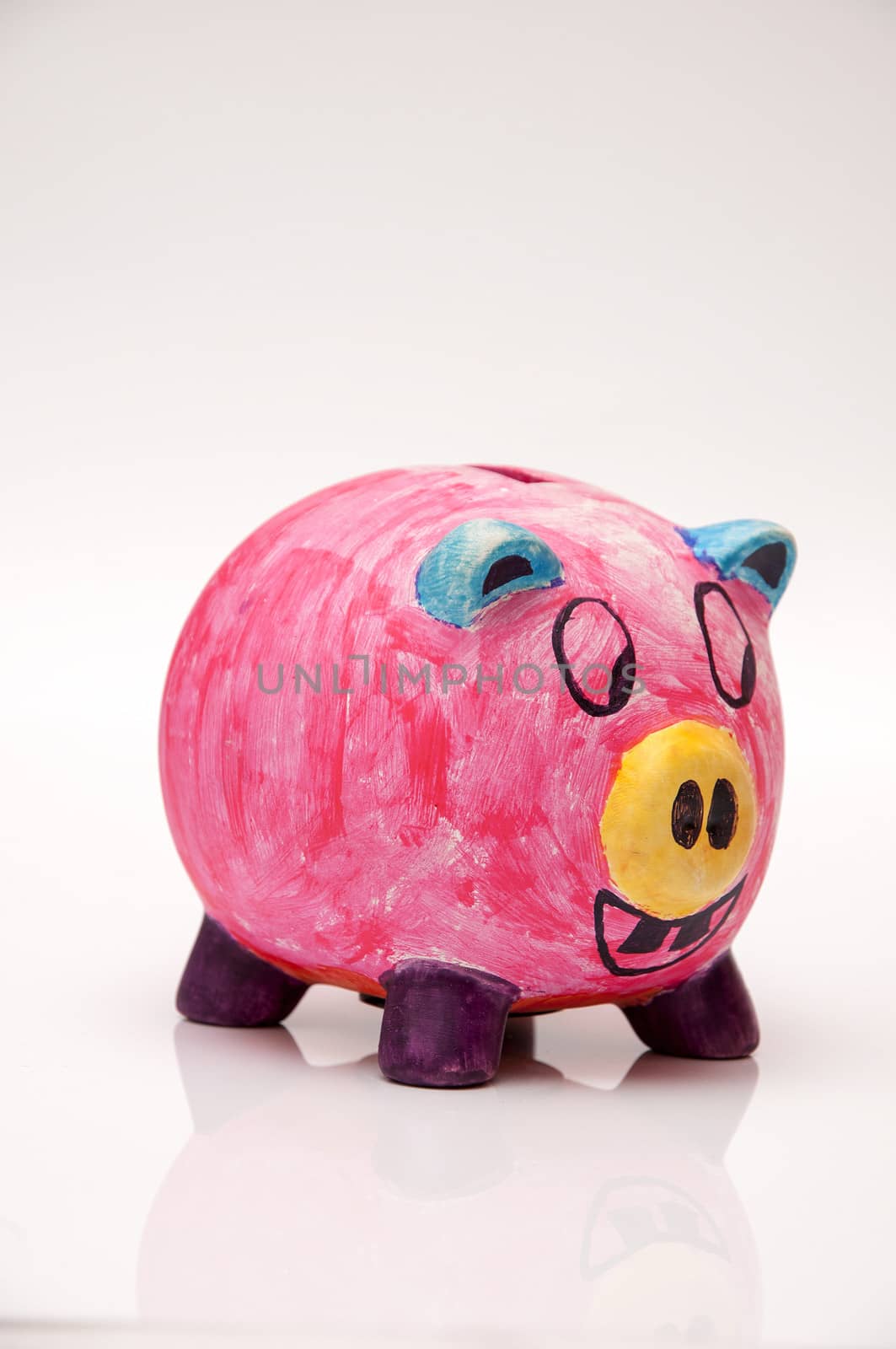 pink piggy bank with eyes and mouth wide