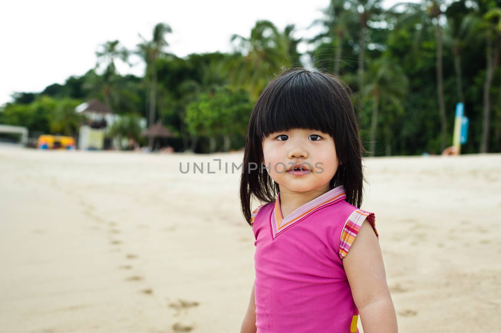 Young toddler at the beach having fun and is curios