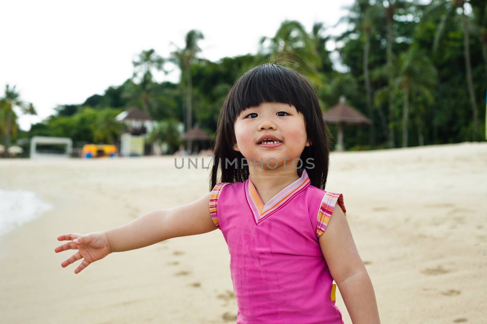 Young toddler at the beach having fun and is curios