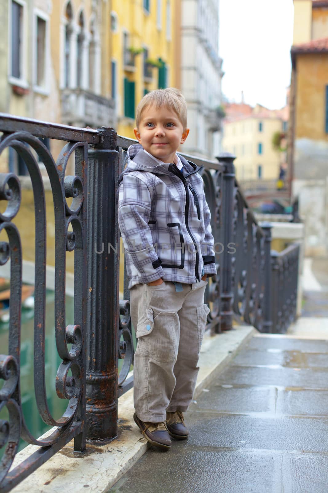 Summer venetian view and tourist boy. Venice, Italy.