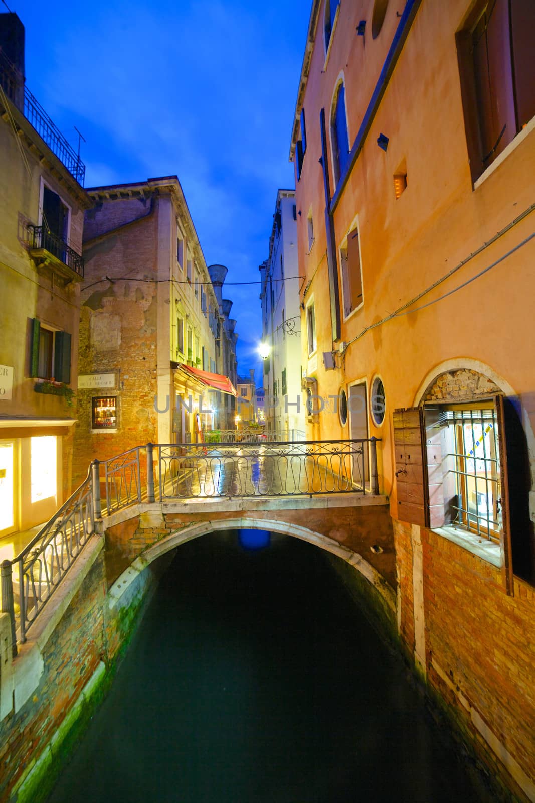 View of a street in venice in the night, Venice, Italy. Vertical view