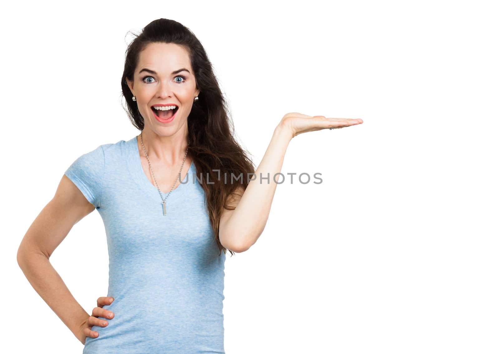 A beautiful happy woman holding out her hand with palm up. Isolated on white.