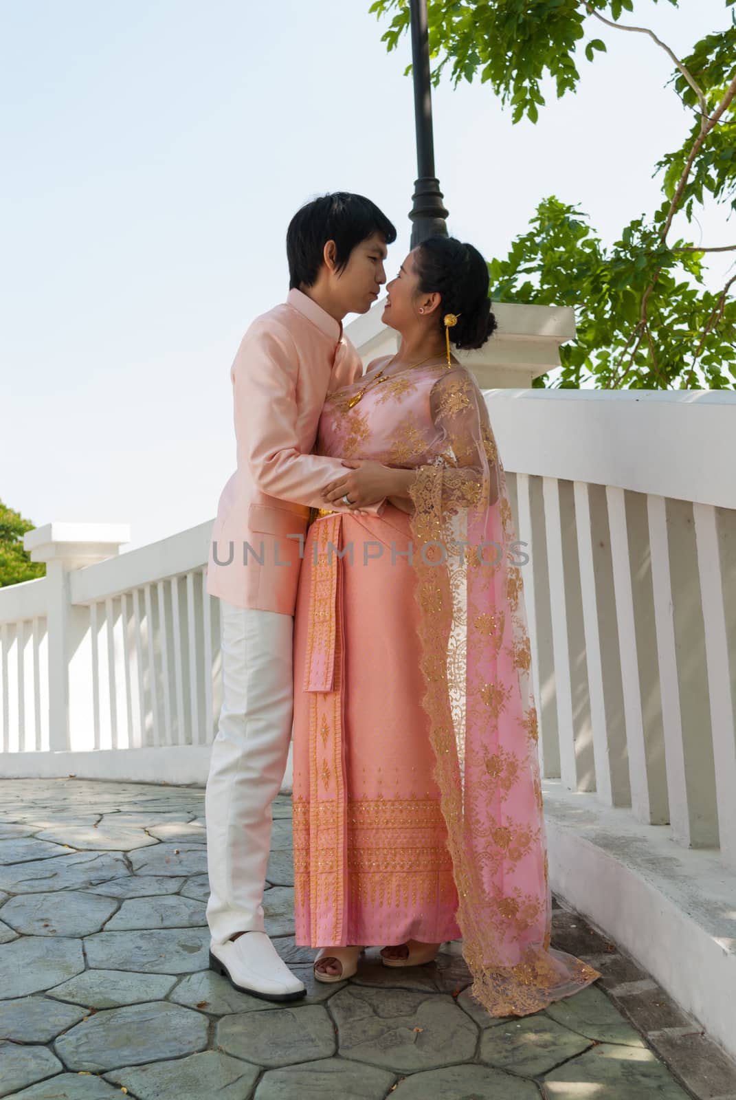 Asian Thai Groom Embracing Cute Bride in Happiness by noneam