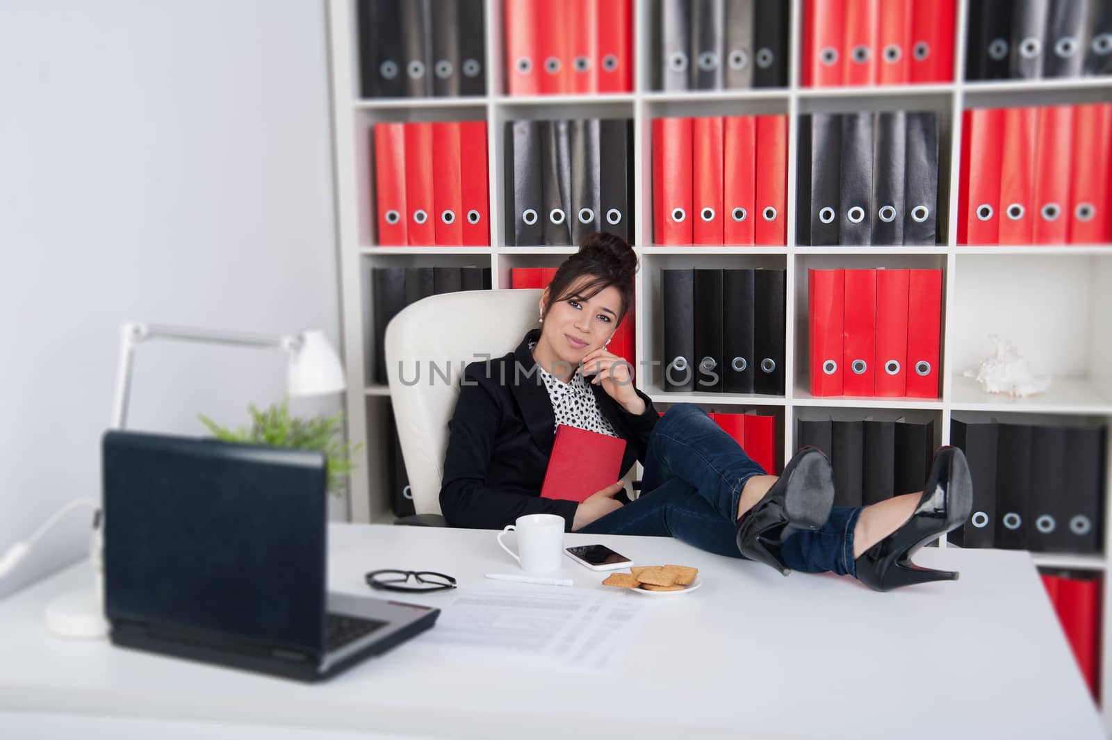 business woman with diary with his legs on the table