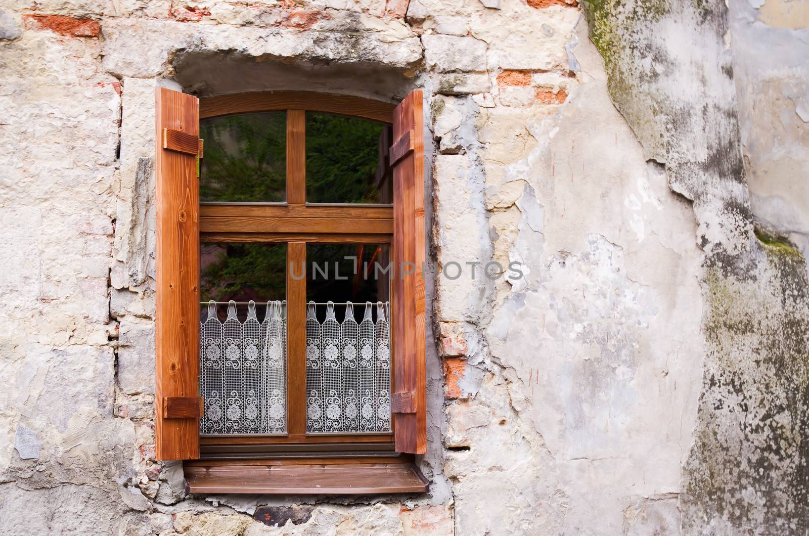 Old window with shutters and lace curtains