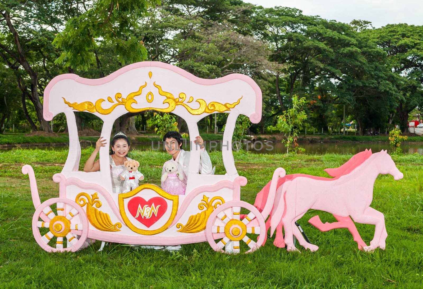 Asian Thai bridal with the wedding teddy bear in romantic carriage with love theme as the Prince and Princess.